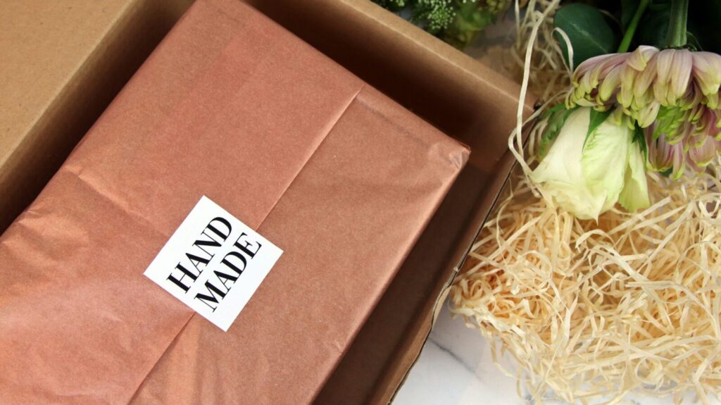Hand Made vinyl label sealing tissue paper in a kraft gift box