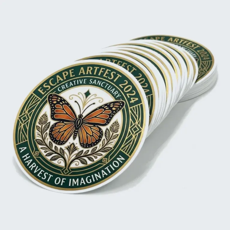 Stack of round custom stickers with a monarch butterfly design